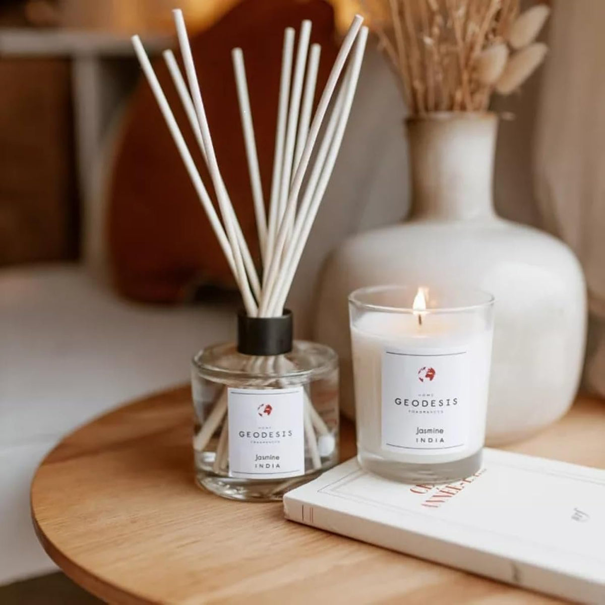 Geodesis Jasmine scented candle lit, showcasing powerful fragrance throw