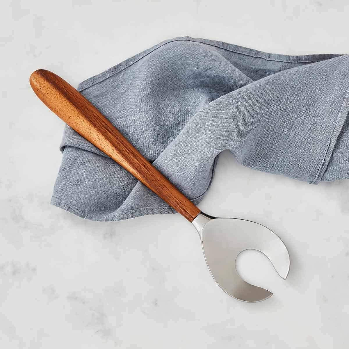 Nambé Curvo Serving Fork close-up showing curved handle detail