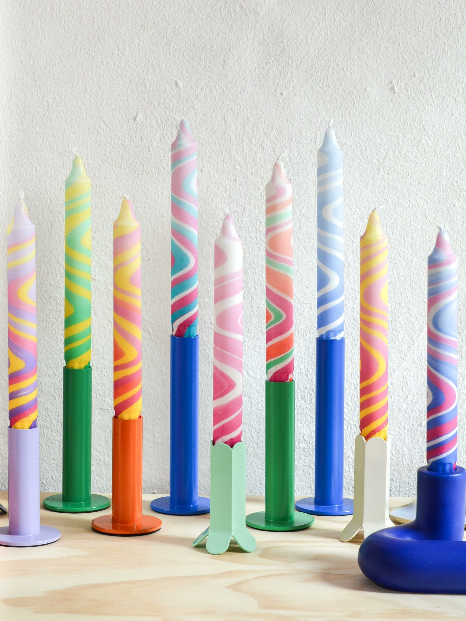 Nordtrice colorful marble taper candles styled in candle holders with solid color base candles