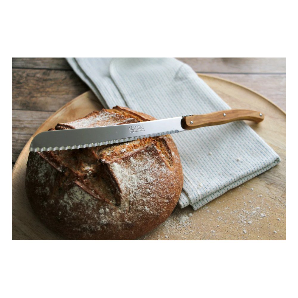 André Verdier Laguiole Debutant Country bread knife olivewood styled on bread board with baguette