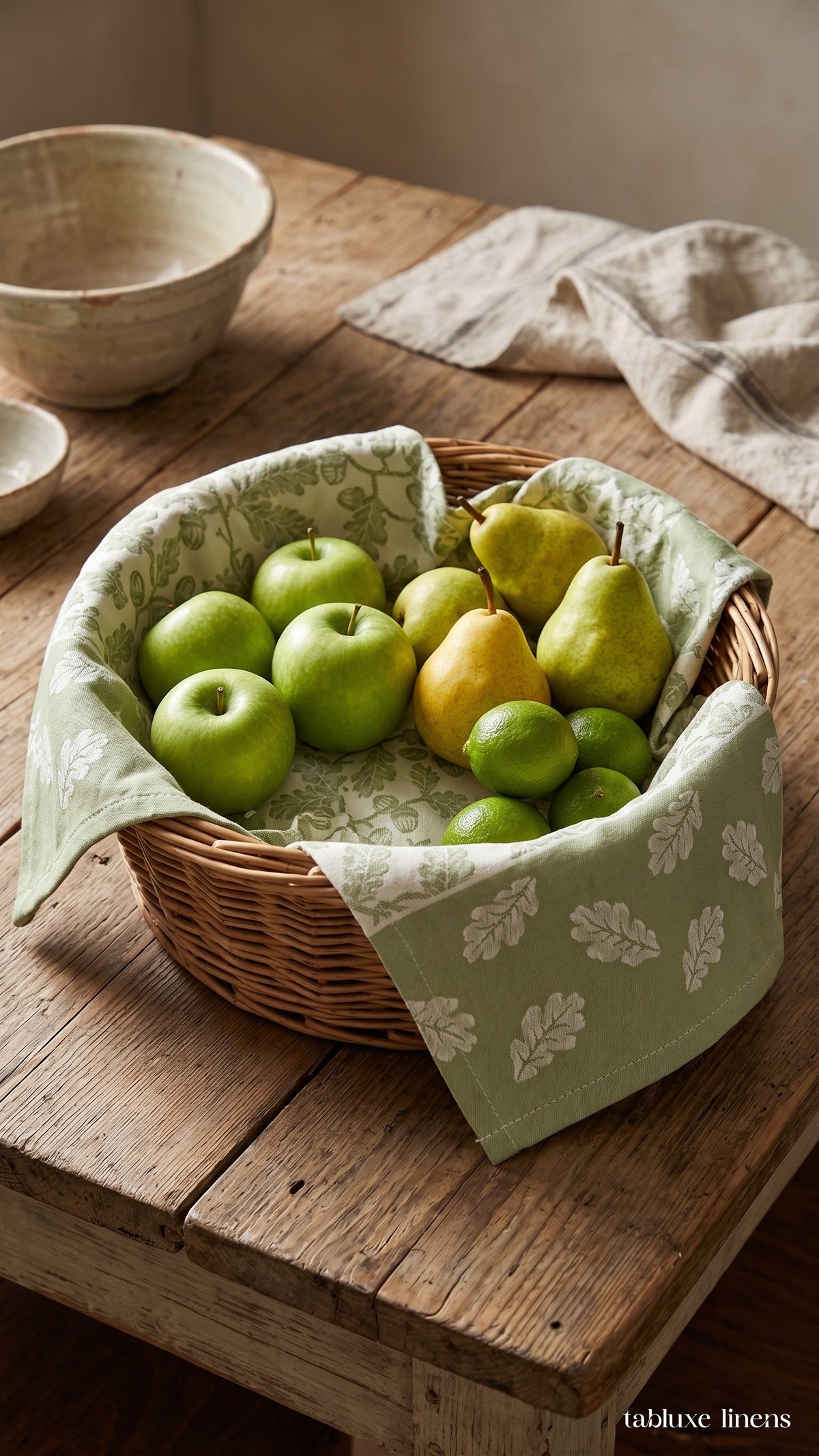 Busatti Rovere Olive Green kitchen towel lining a wicker fruit basket