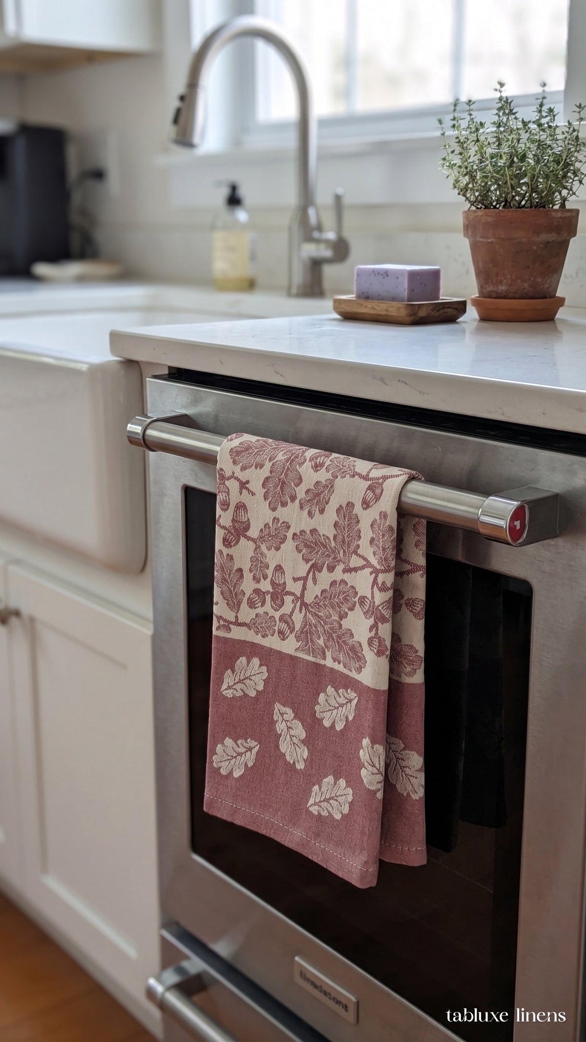 Busatti Rovere Burgundy tea towel hanging on kitchen sink oven handle