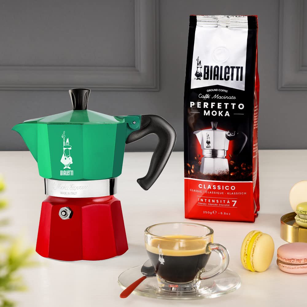 Close-up of Bialetti Moka Express Italia Tricolore showing iconic moustache man logo and Italian flag color detail