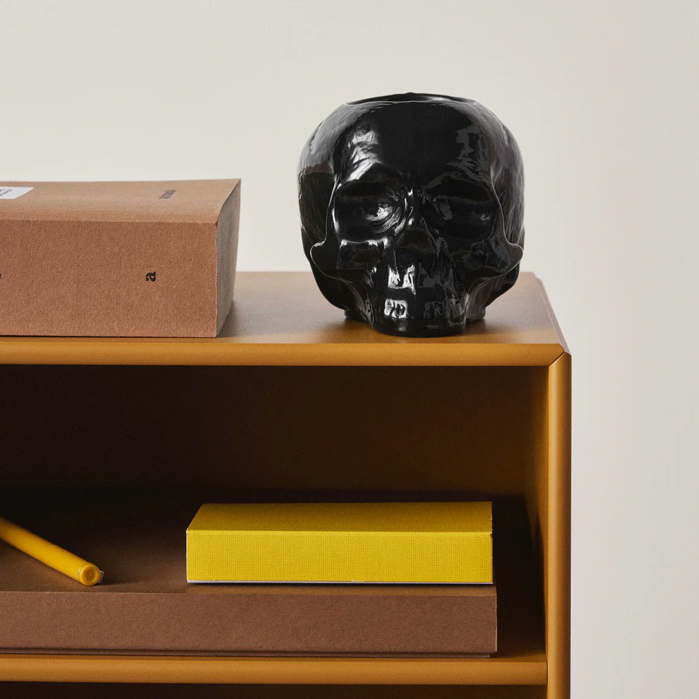 Close-up of Kosta Boda Still Life black skull votive showing glossy reflective glass surface