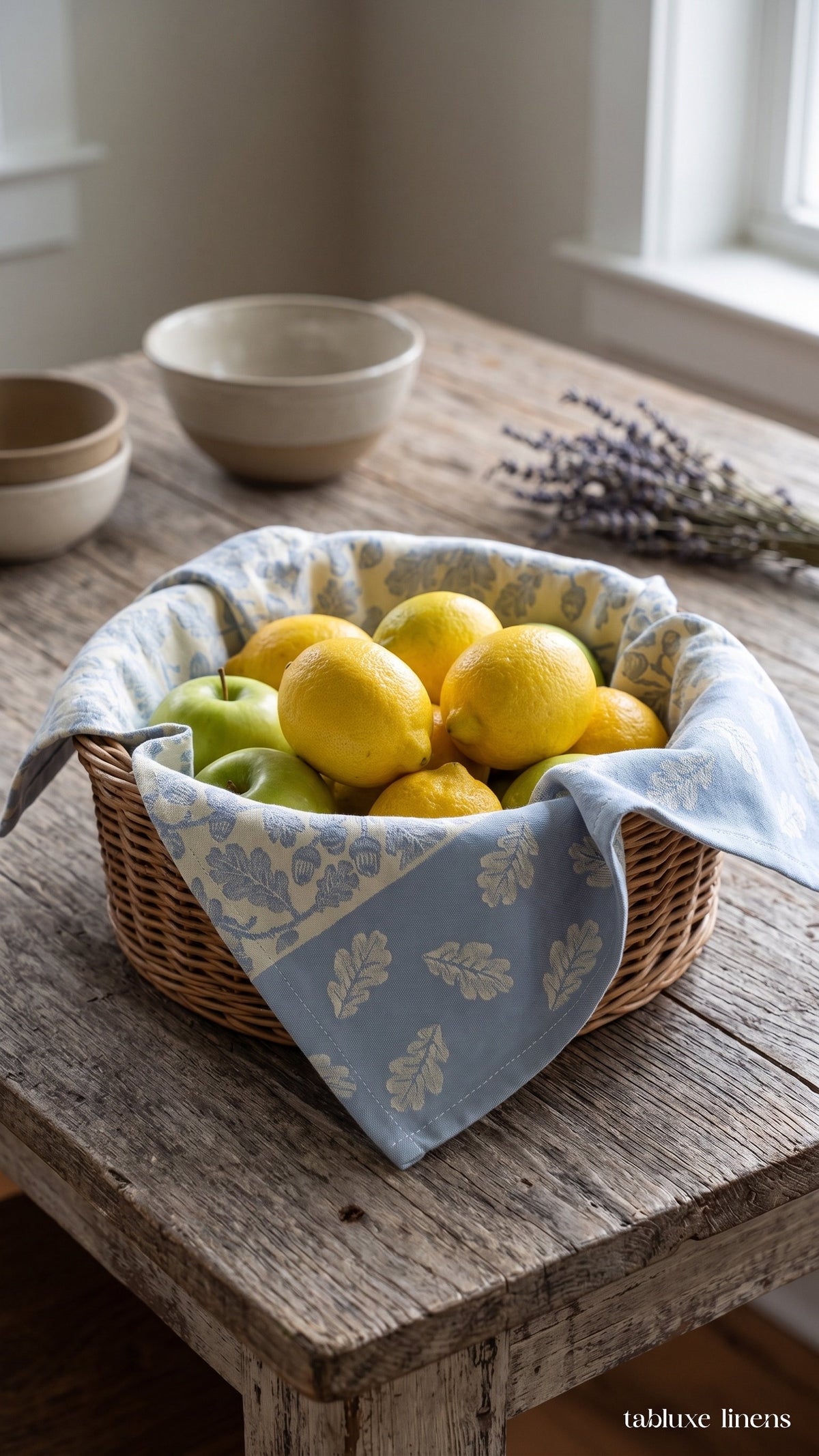 Busatti Rovere Light Blue kitchen towel lining a wicker fruit basket