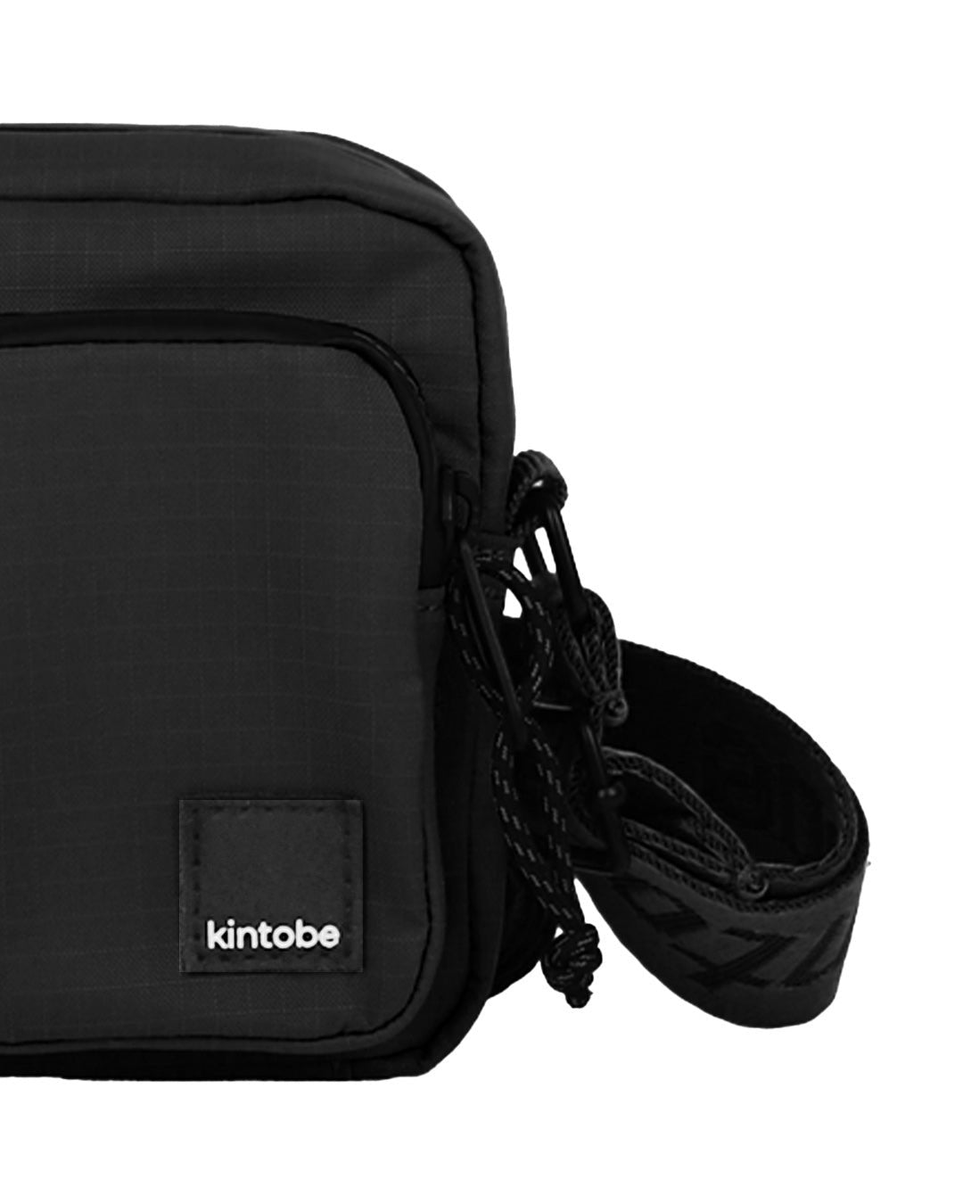 Close-up of Kintobe Mini Miles black crossbody showing front pockets zipper and mushroom leather logo label