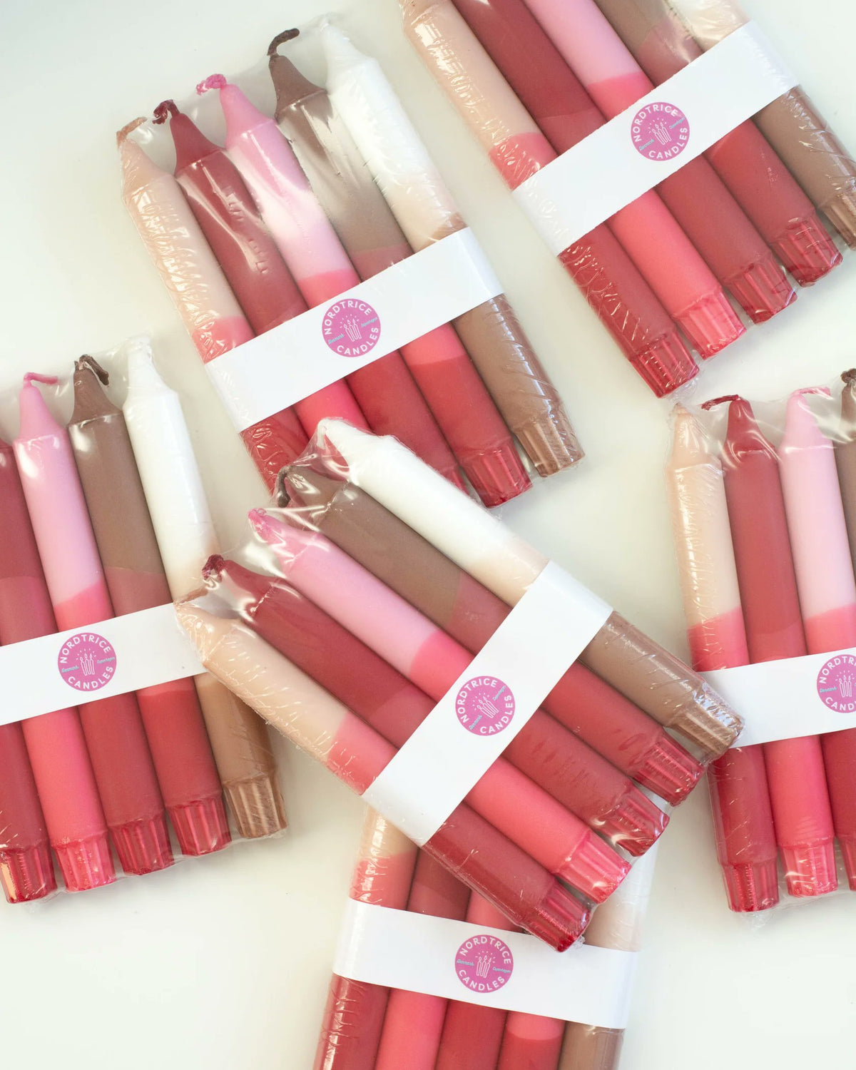 Nordtrice nude and pink handmade taper candles scattered loose arrangement
