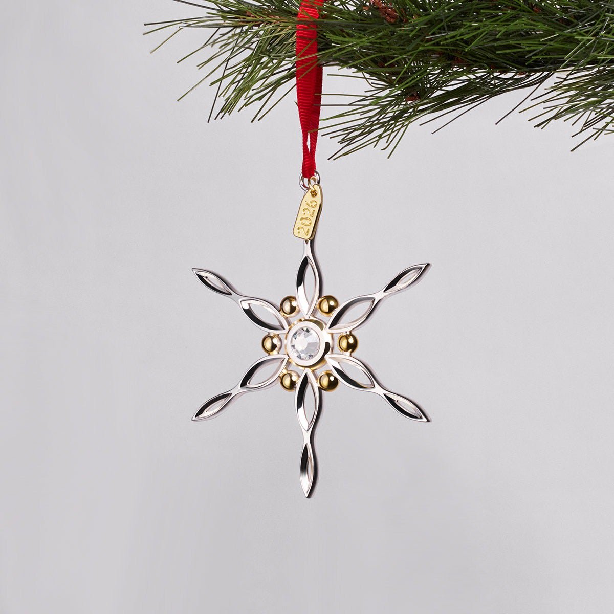 Nambé 2026 Snowflake Ornament styled hanging on Christmas tree