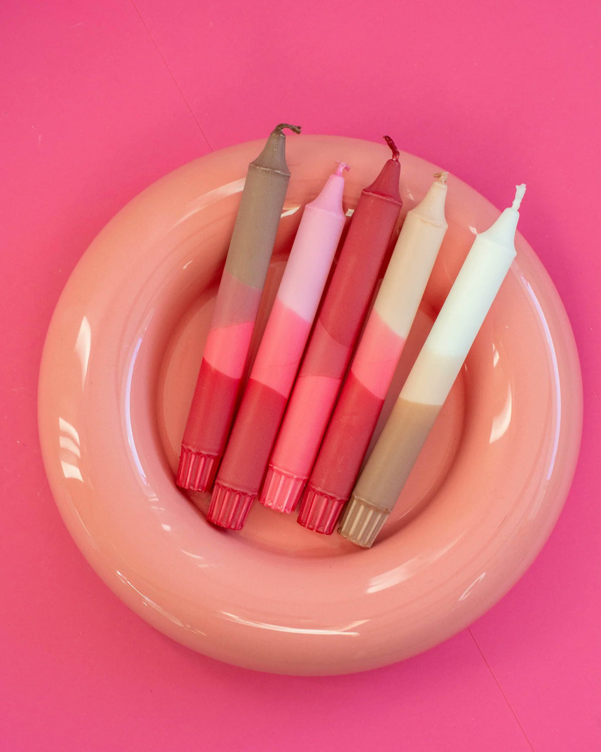 Nordtrice handmade pink taper candles displayed in decorative bowl