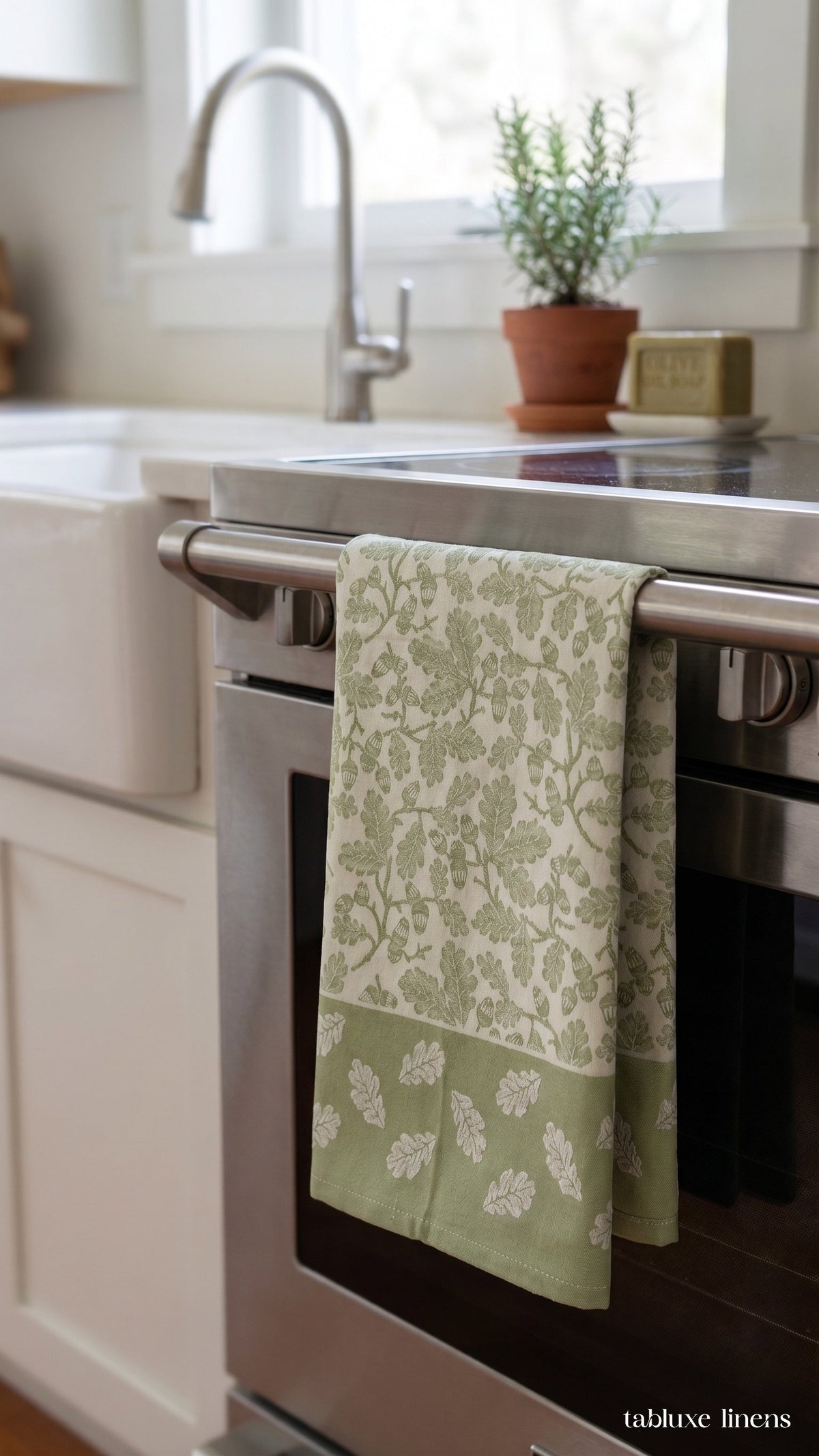 Busatti Rovere Olive Green tea towel hanging on kitchen sink oven handle