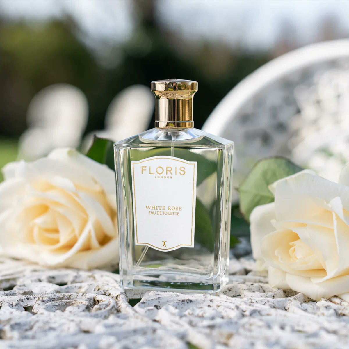 Floris London White Rose perfume styled with roses