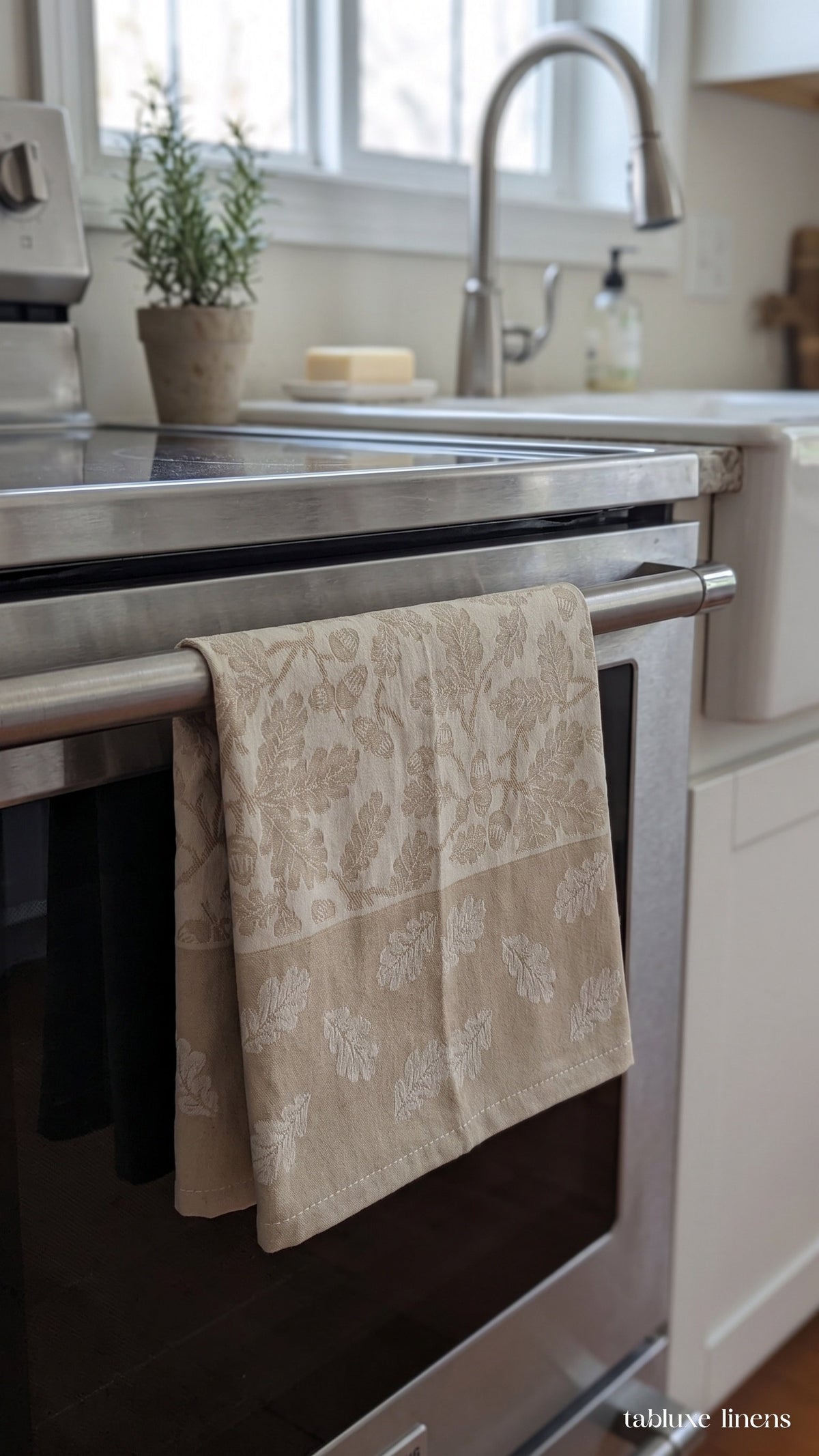 Busatti Rovere Sand tea towel hanging on kitchen sink oven handle