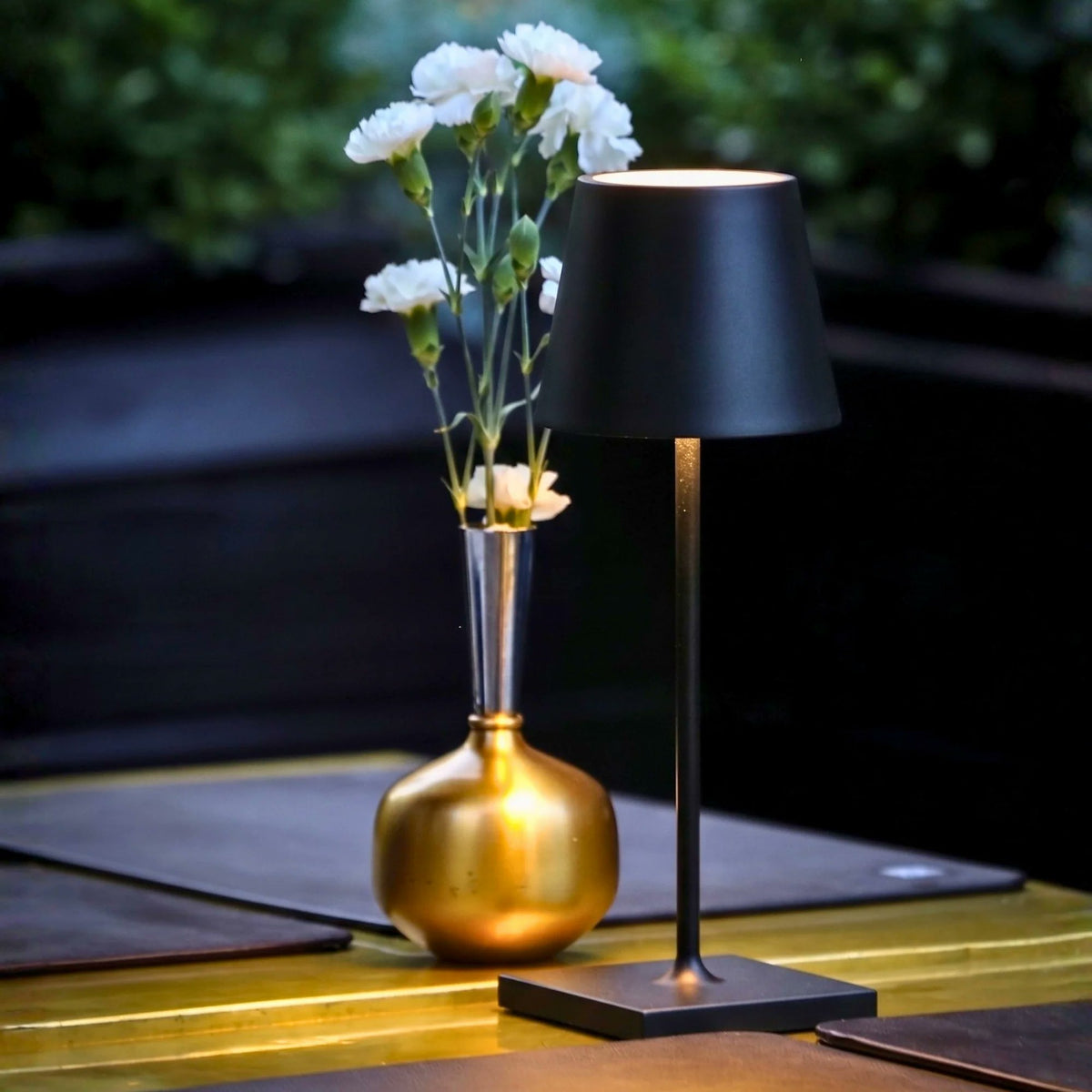 Zafferano Poldina Pro Mini cordless lamp styled on outdoor patio table evening entertaining