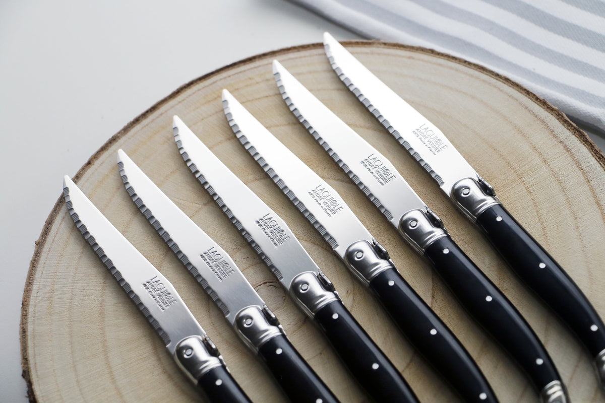 André Verdier Laguiole Debutant black handle flatware close-up bee emblem mirror finish