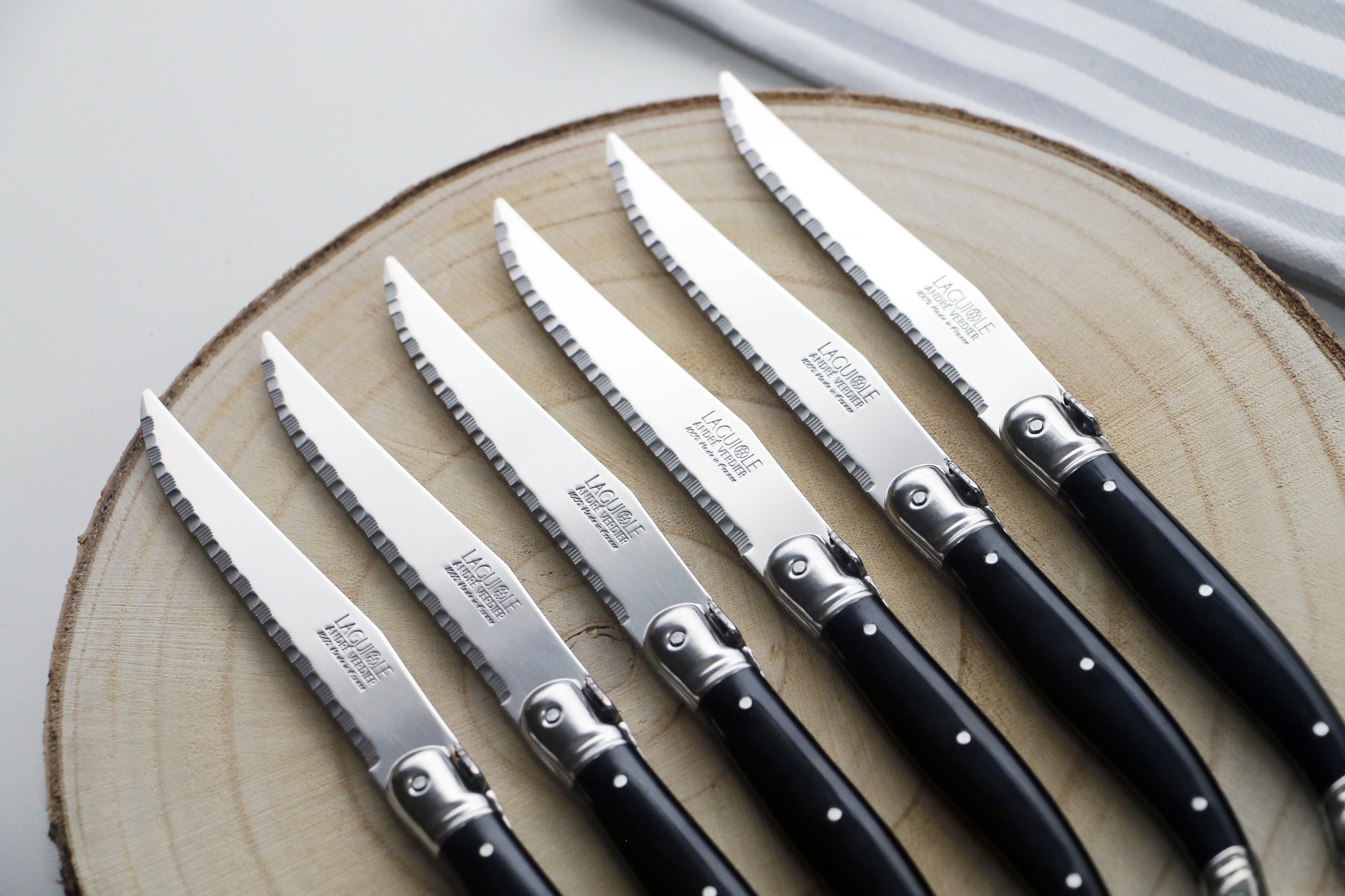 André Verdier Laguiole Debutant black handle flatware close-up bee emblem mirror finish