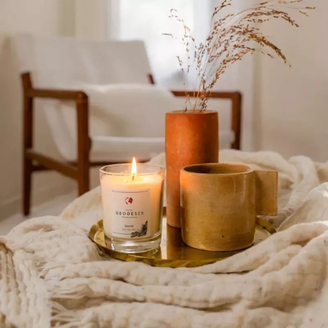 Geodesis sandalwood candle lit, showcasing powerful scent diffusion