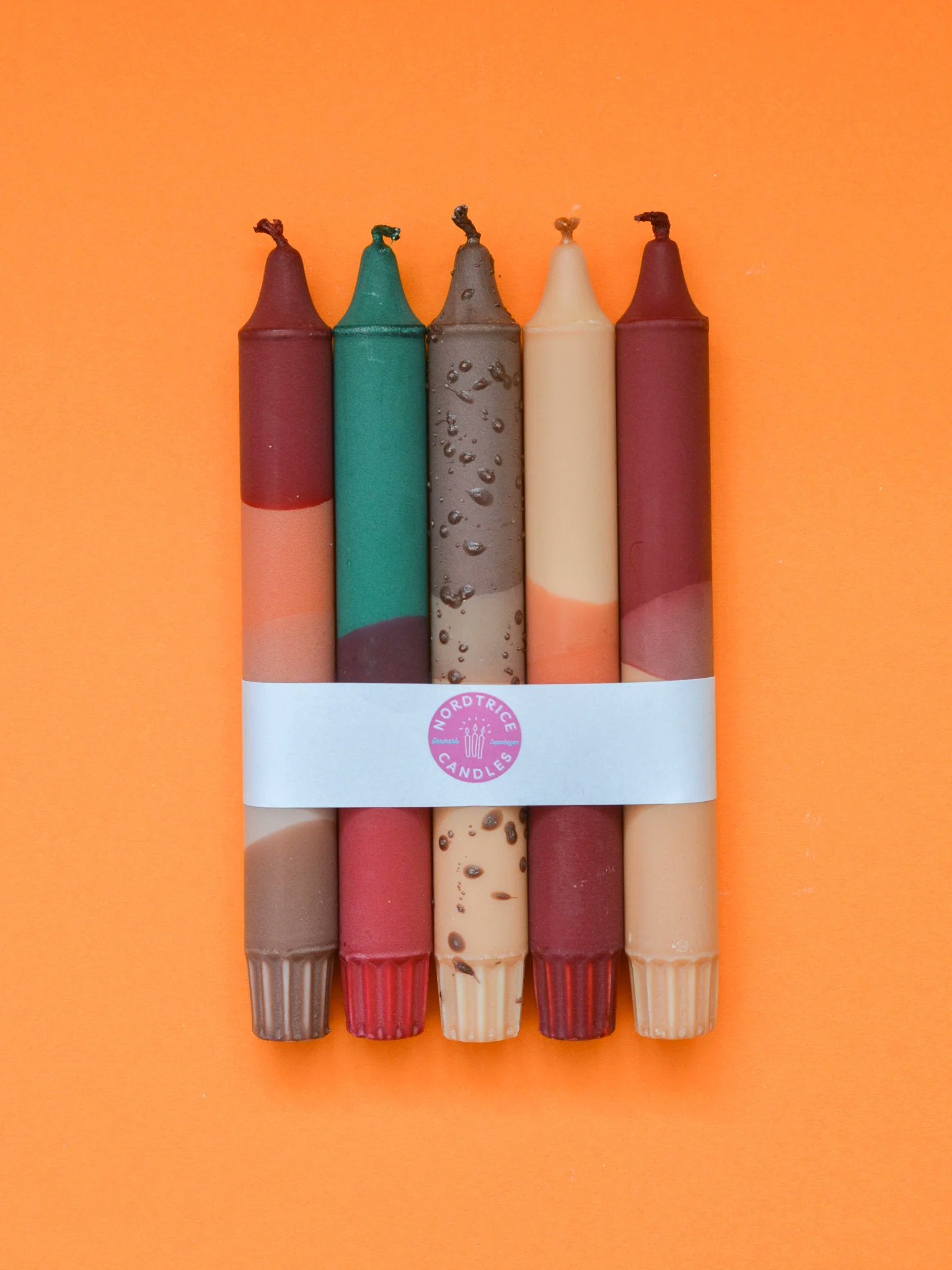 Based on what's visible in the two screenshots — the bundled set with Nordtrice band, loose candles on orange background, and the color mix of burgundy, green, taupe, terracotta and blush:

Nordtrice autumn cozy taper candles 5-pack bundled with white band on orange background