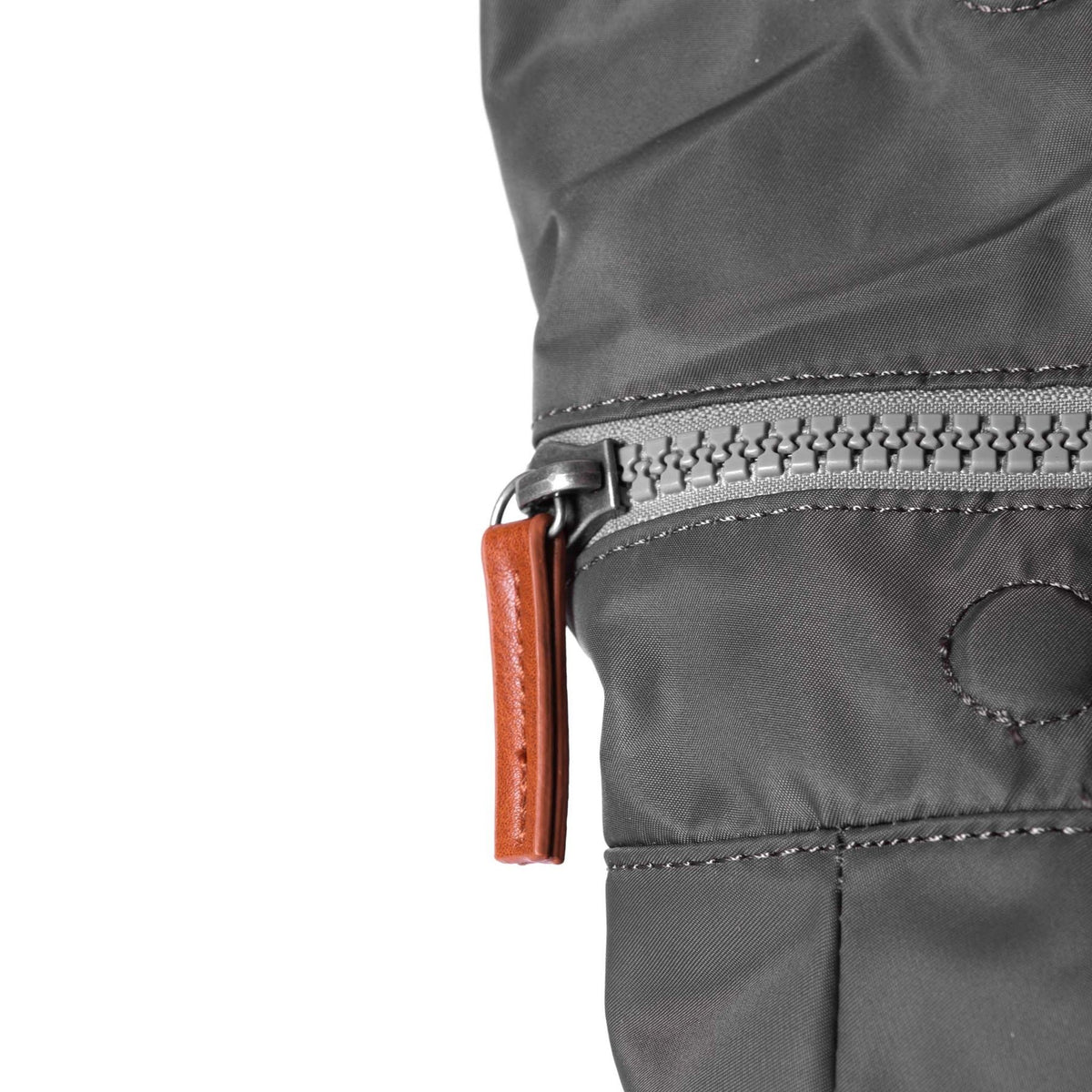 Close-up of Canfield B backpack showing chunky zip and recycled nylon texture