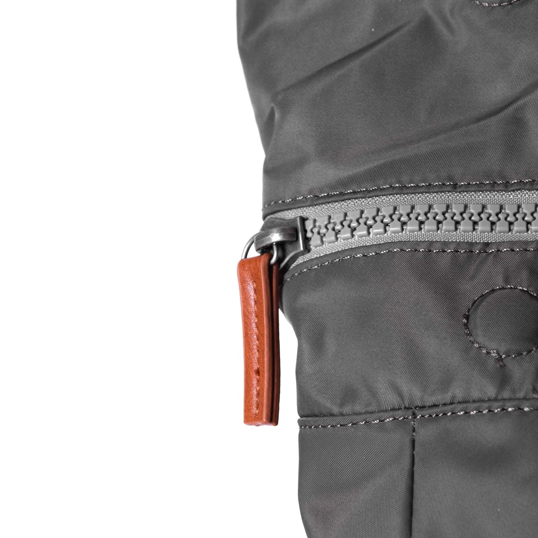 Close-up of Canfield B backpack showing chunky zip and recycled nylon texture