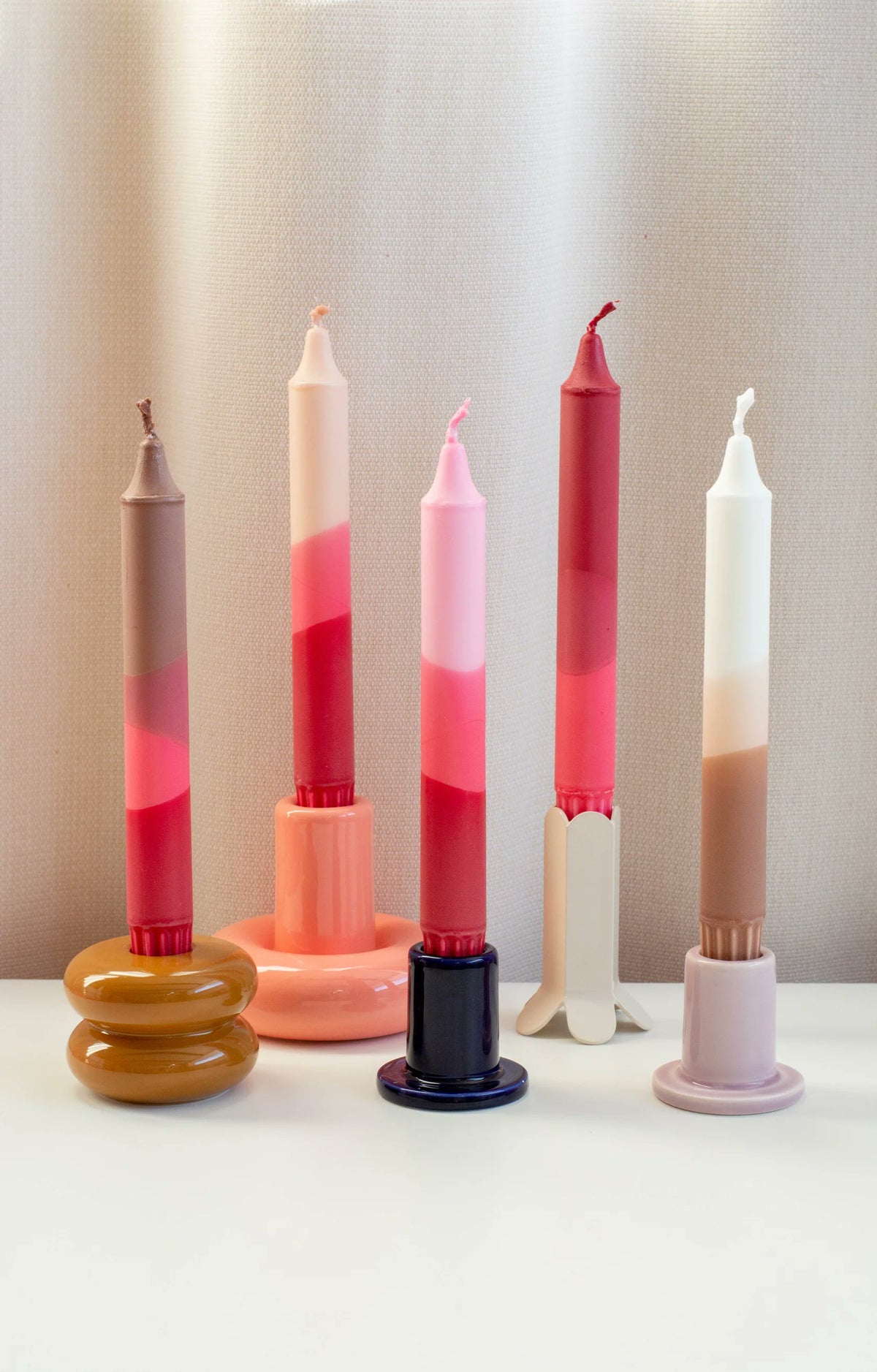 Nordtrice pink dip-dyed taper candles close-up showing ribbon detail