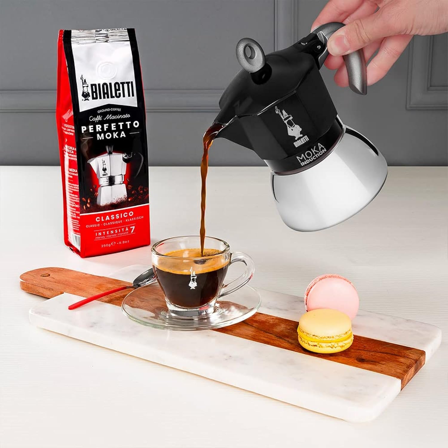 Close-up of Bialetti Moka Induction showing stainless steel boiler aluminum upper and iconic moustache man logo