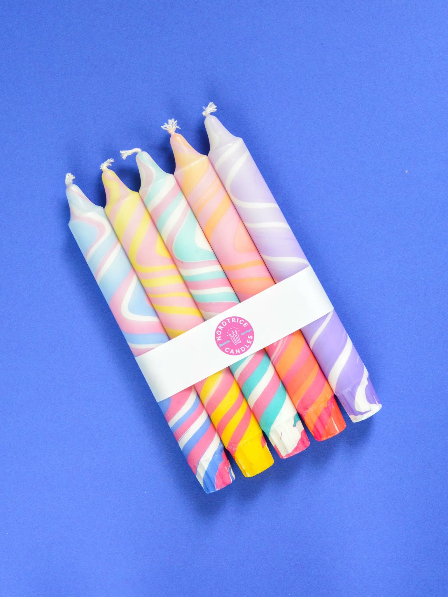 Handmade marble swirl taper candles in pink orange yellow and turquoise by Nordtrice Copenhagen