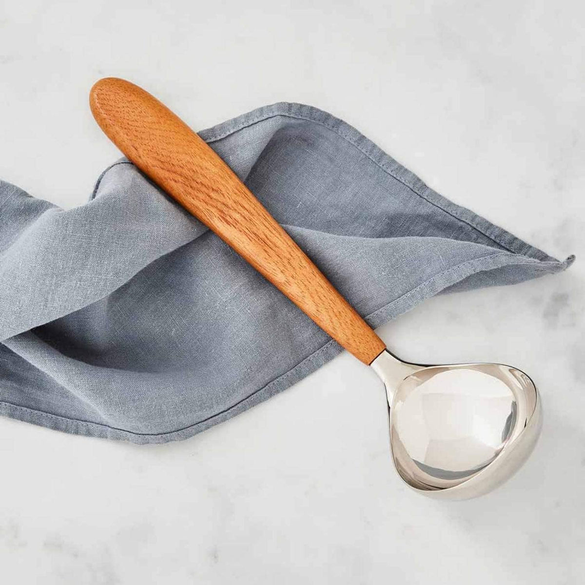 Nambé Curvo Ladle close-up showing curved handle detail