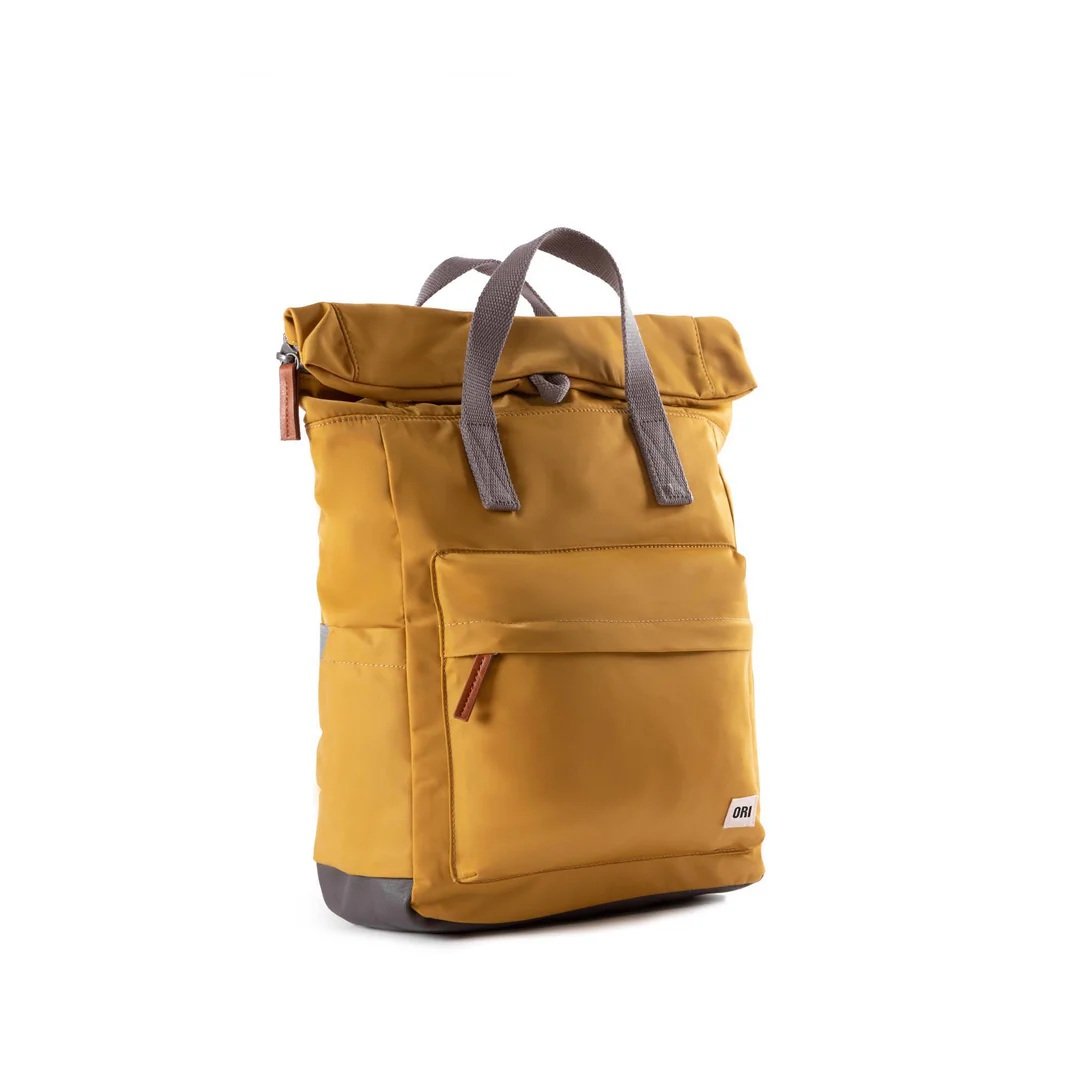 Yellow weatherproof roll-top backpack with wide-mouth zip and magnetic closure
