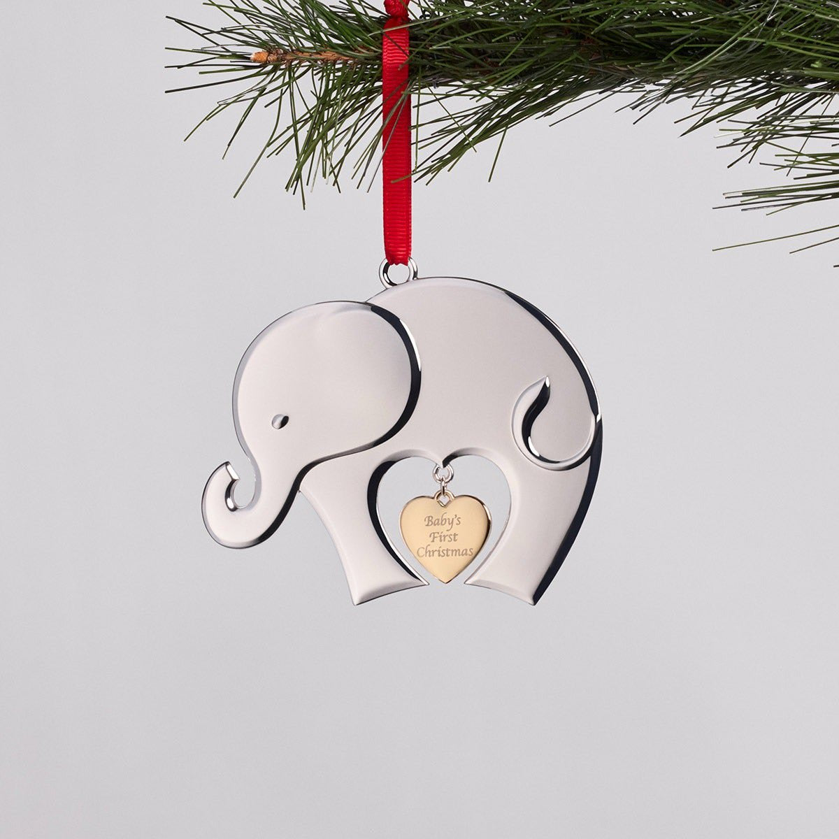 Nambé Baby's First Christmas Ornament styled hanging on Christmas tree