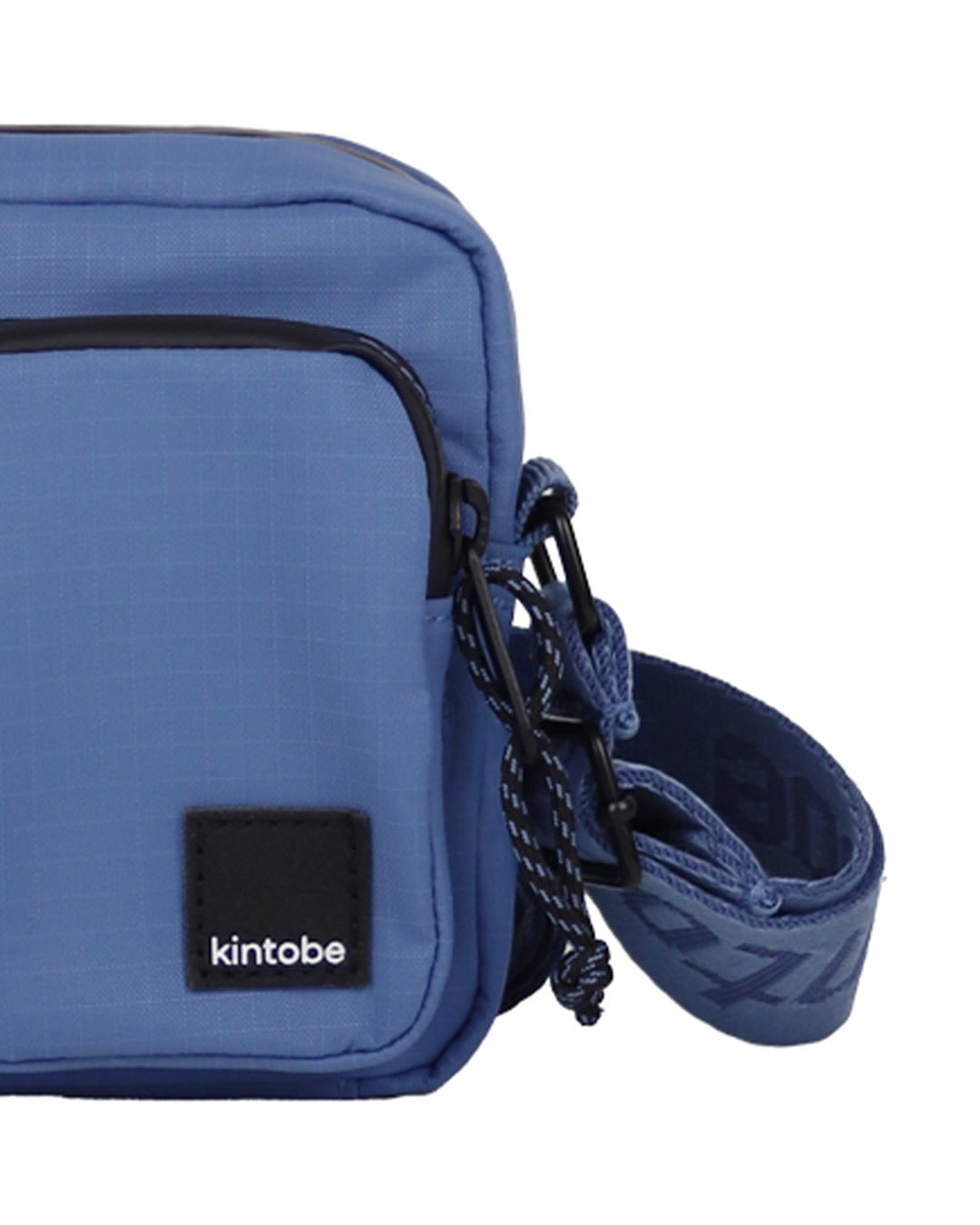 Close-up of Kintobe Mini Miles storm blue crossbody showing front pockets zipper and mushroom leather logo label
