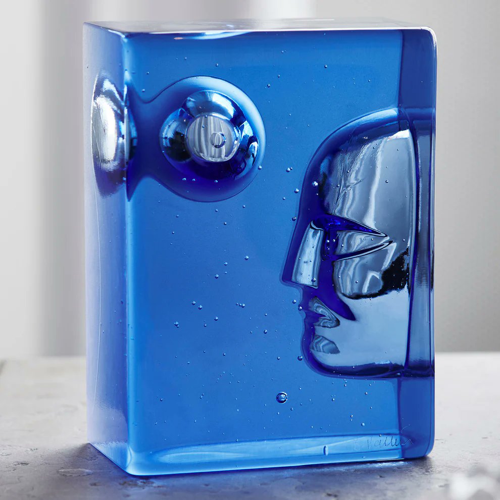 Close-up of Kosta Boda Azur Moon showing face impression and moonlight detail in deep blue cast glass
