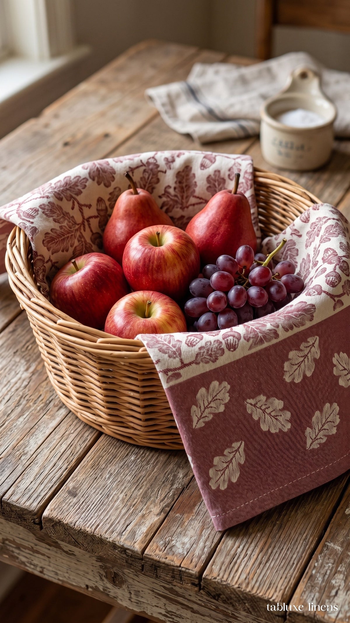 Busatti Rovere Burgundy kitchen towel lining a wicker fruit basket