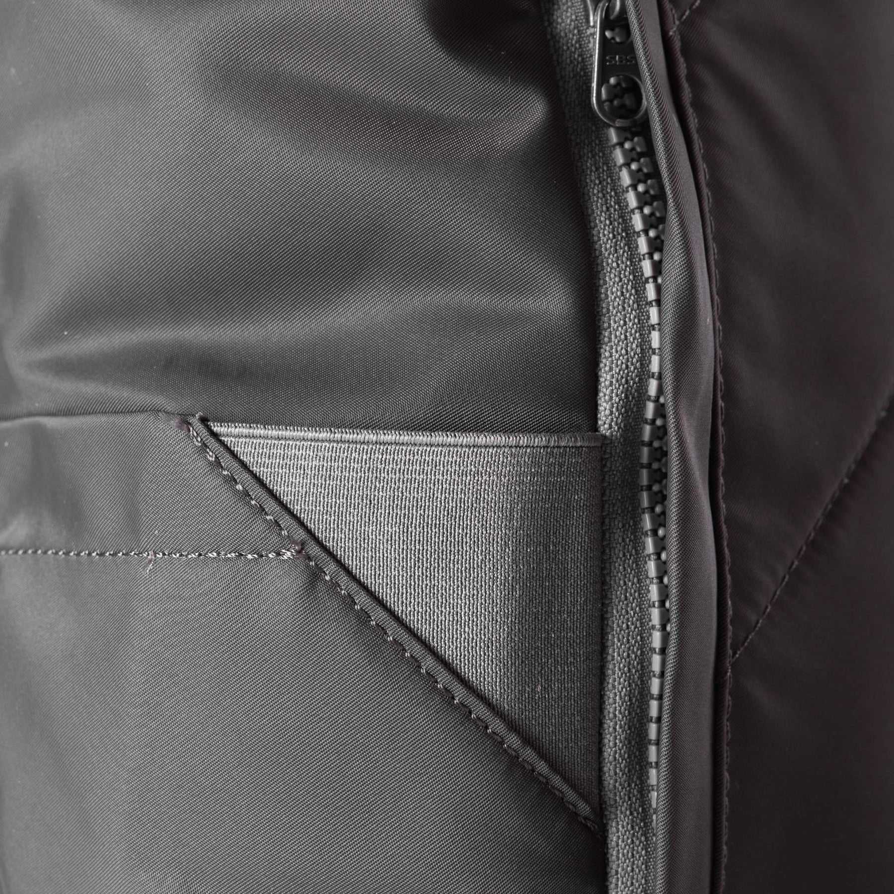 Graphite grey roll-top backpack with magnetic closure and side bottle pockets