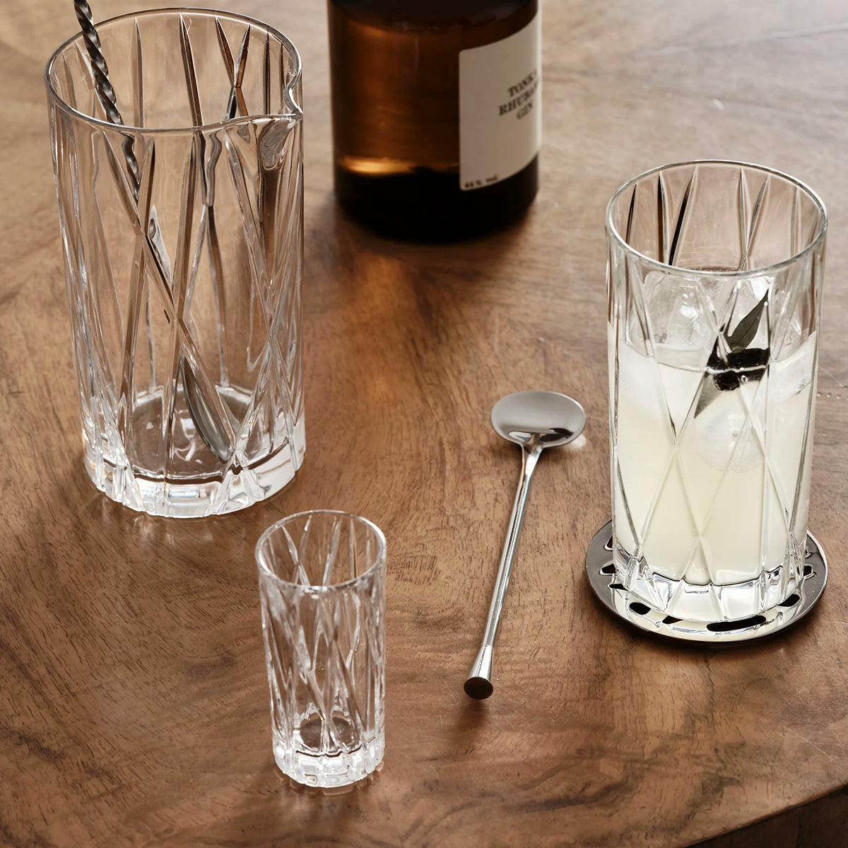 Orrefors City Shot Glasses styled on bar cart with spirits