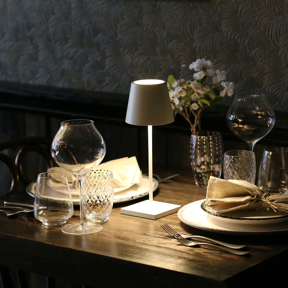 Zafferano Poldina Pro Mini white cordless lamp styled on dining table indoor warm ambient light