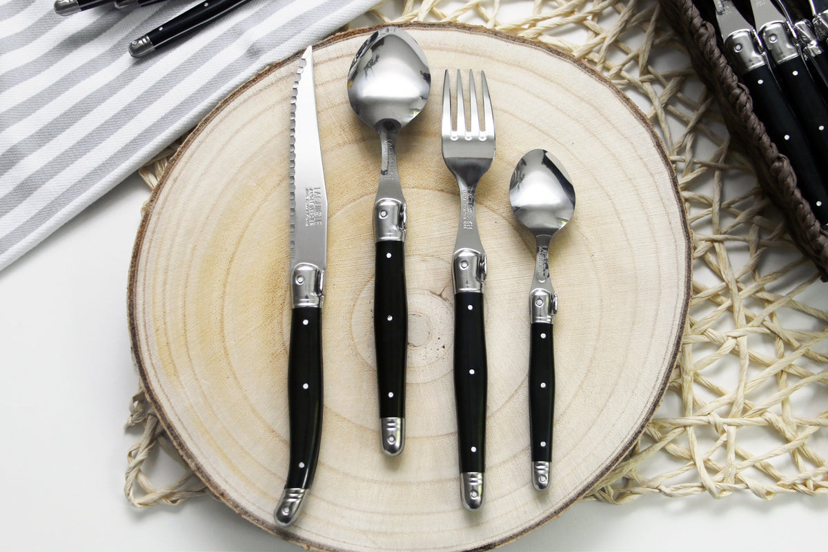 André Verdier Laguiole Debutant 24pc black flatware set styled on formal dining table