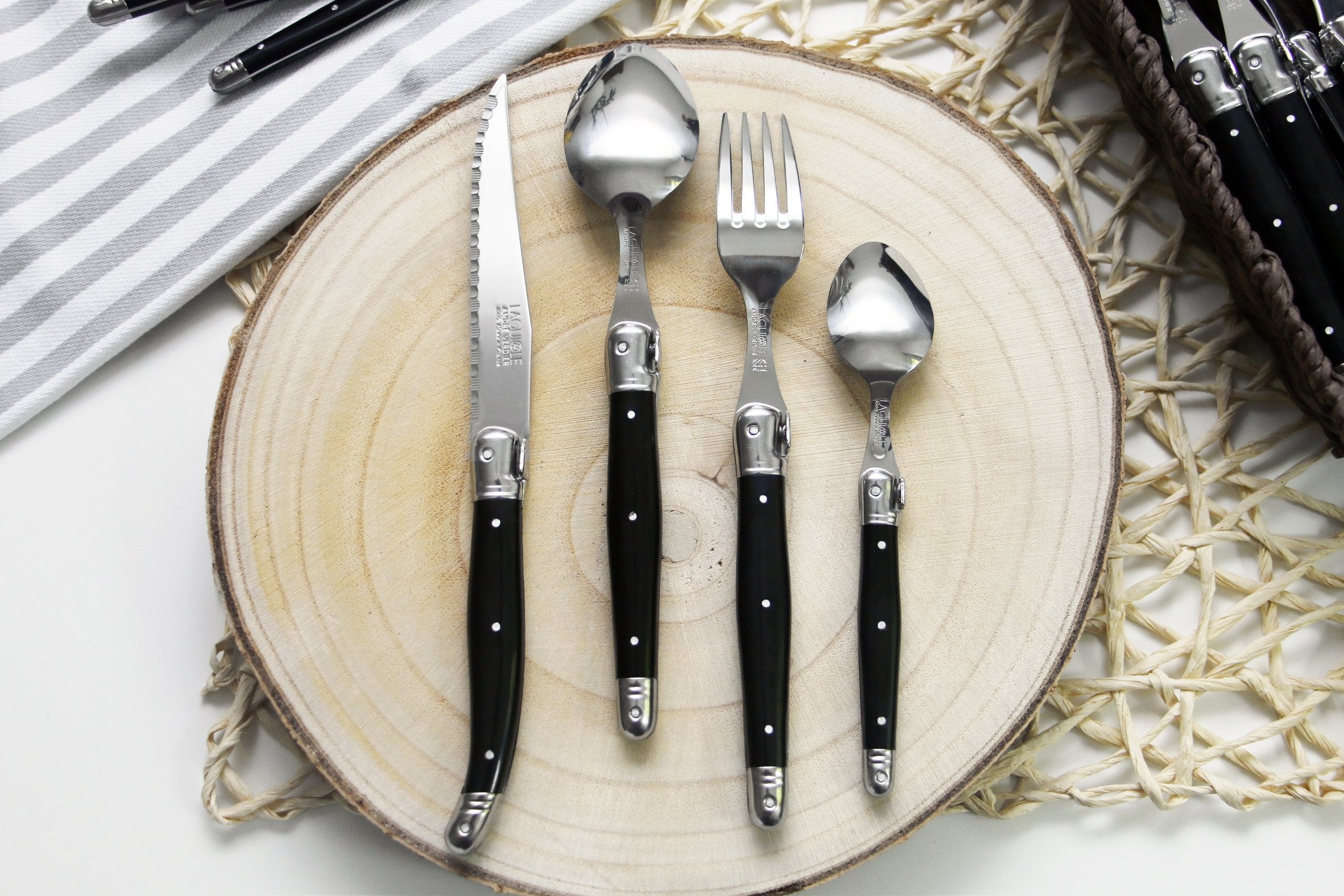 André Verdier Laguiole Debutant 24pc black flatware set styled on formal dining table