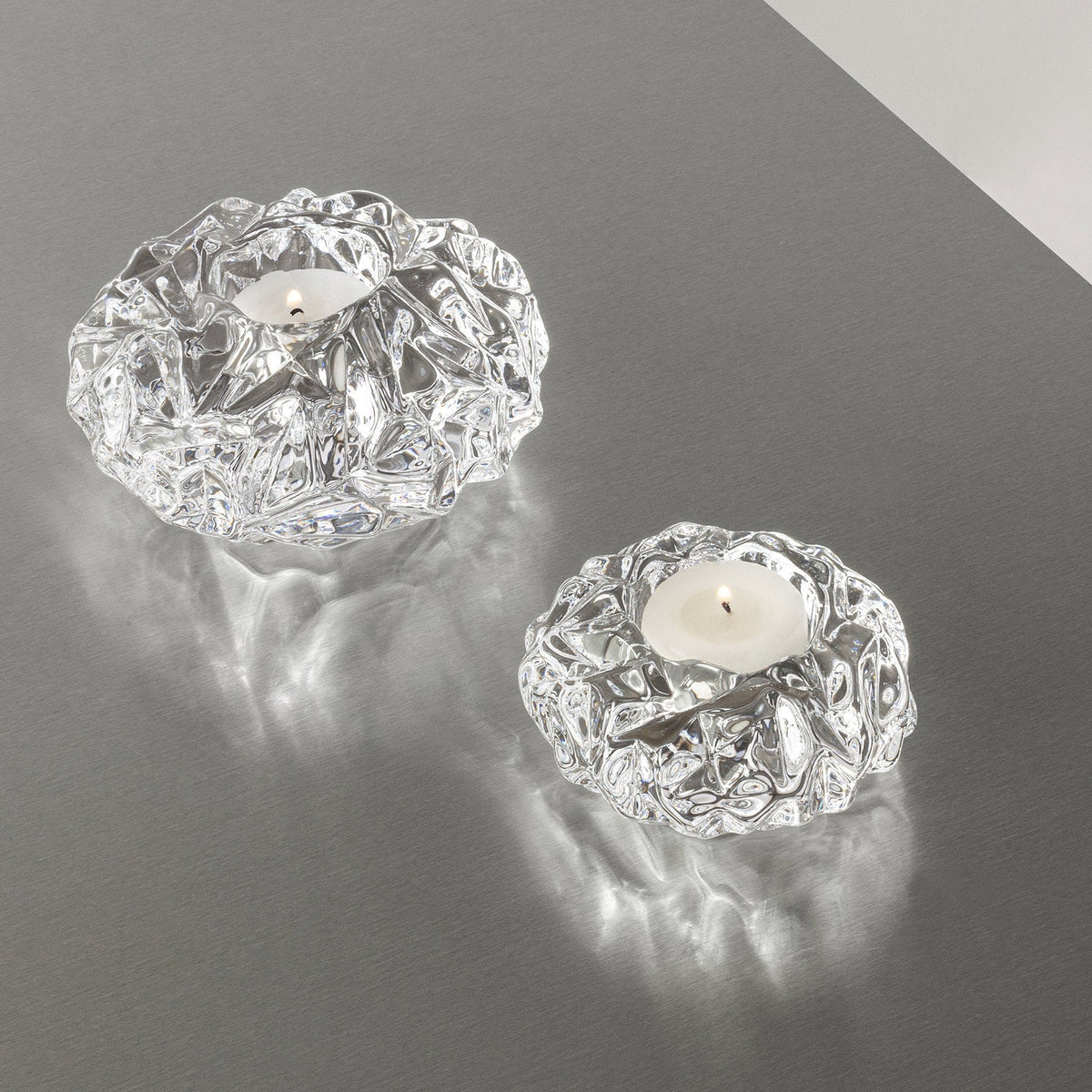 Orrefors Carat Votive Small styled with lit candle on table