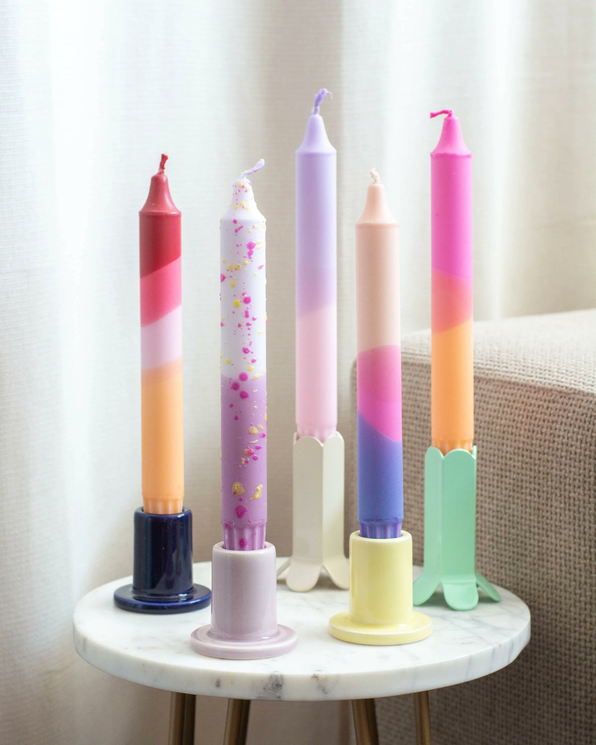 Handmade pastel taper candles in pink lavender peach and periwinkle by Nordtrice Copenhagen
