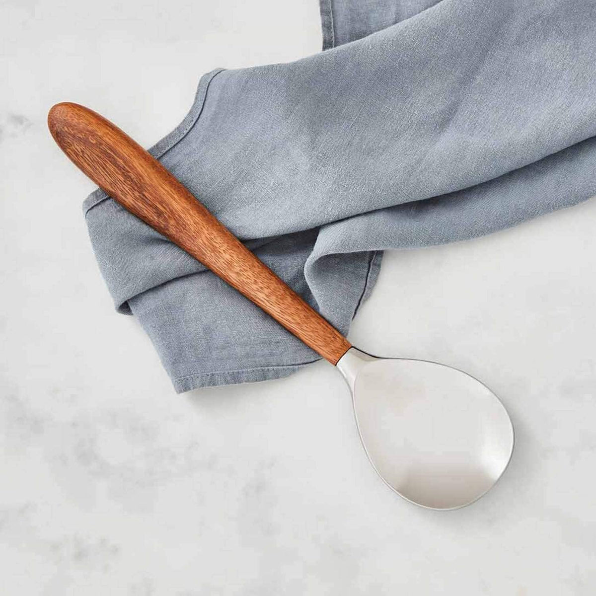 Nambé Curvo Serving Spoon close-up showing curved handle detail