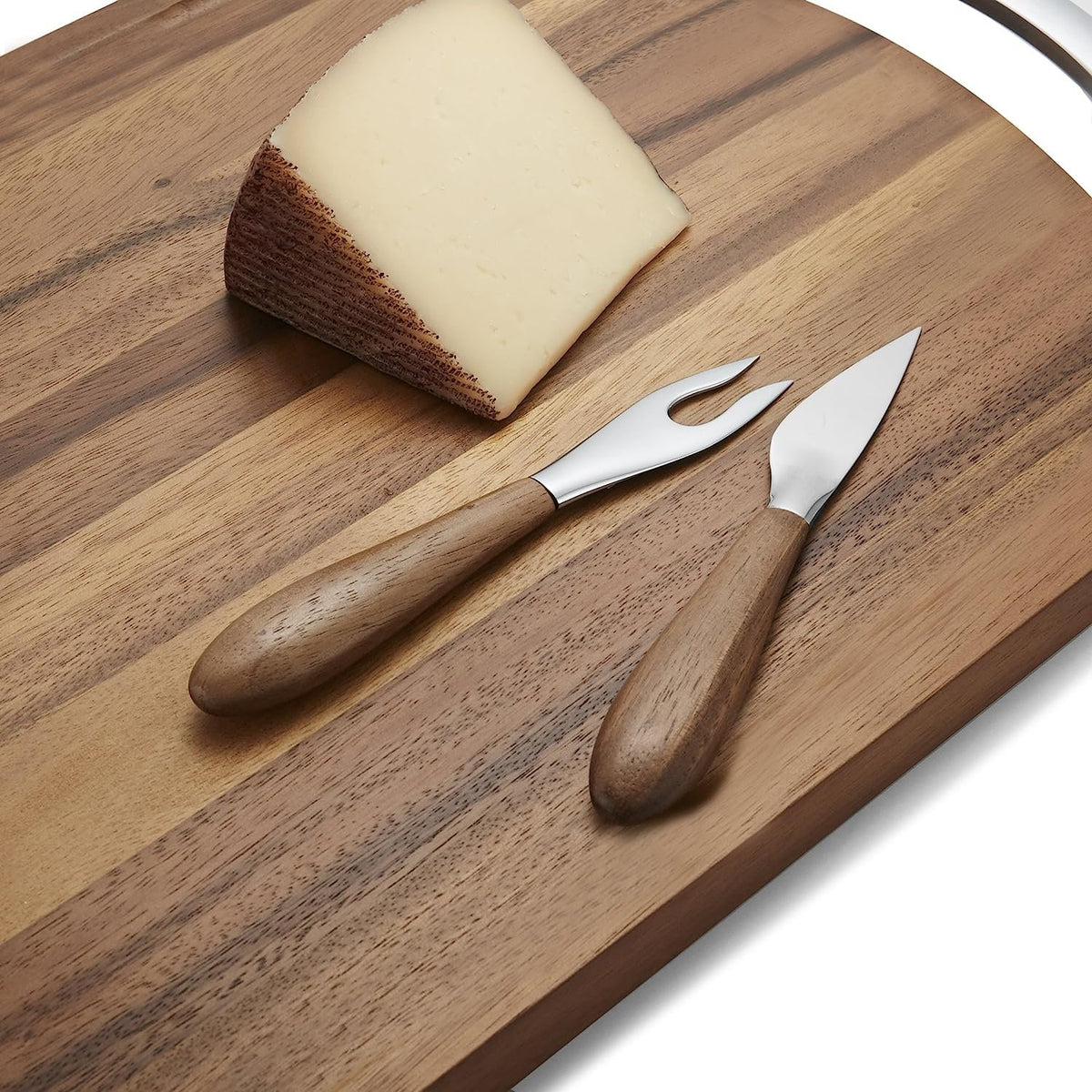 Nambé Curvo Cheese Knife close-up showing curved handle detail