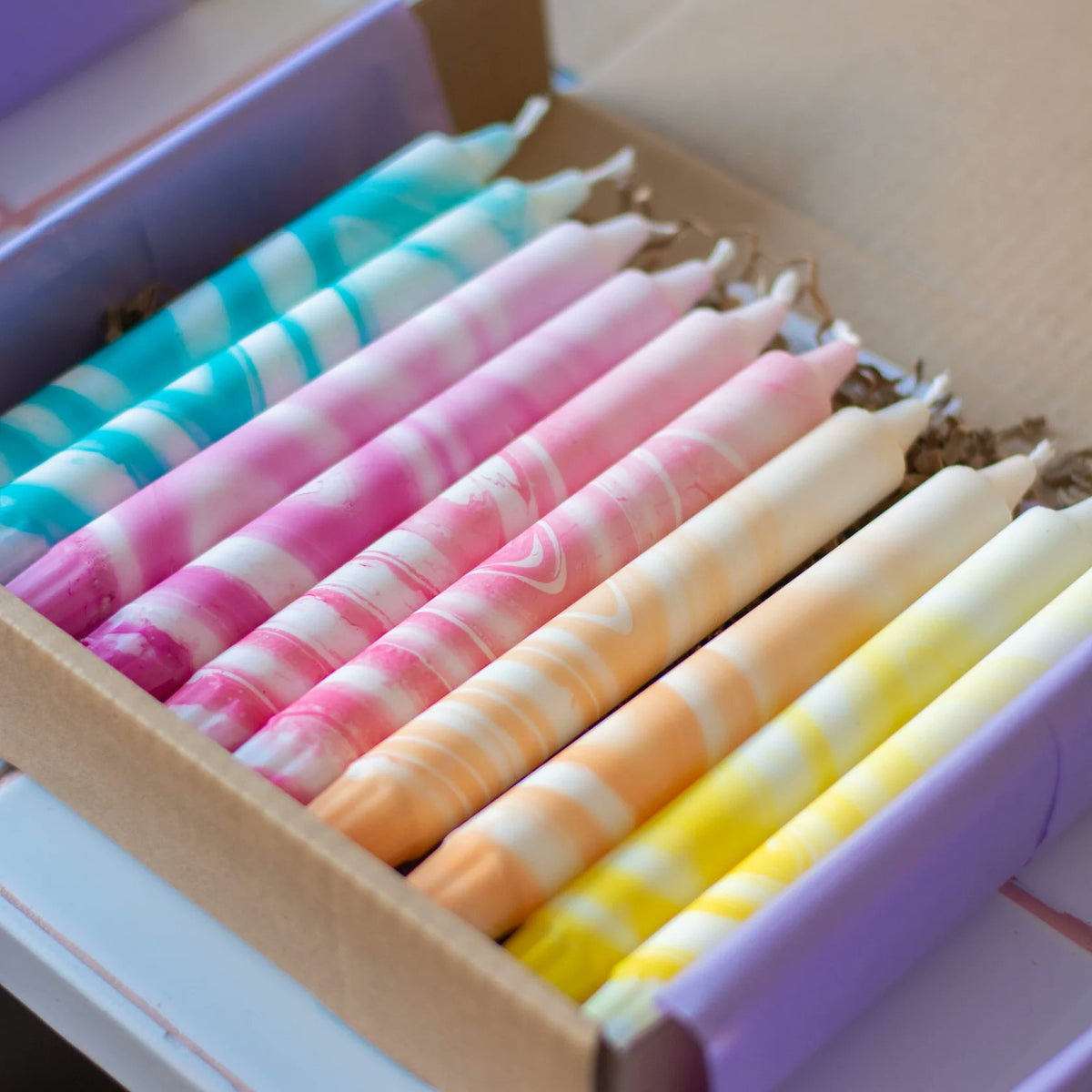 Handmade Danish marble taper candles in turquoise pink red and yellow